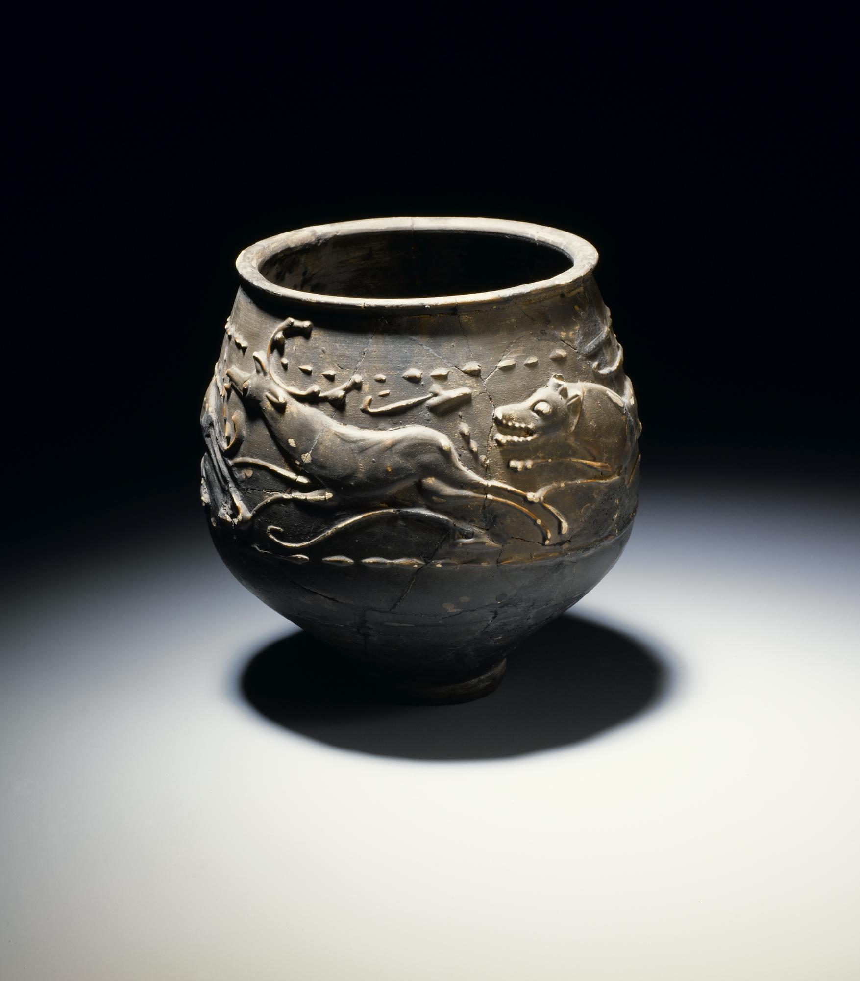 Image of Castor ware beaker decorated with a chase scene showing stag, hind and hounds, from the Roman site at Newstead, 140 - 180 AD © National Museums Scotland